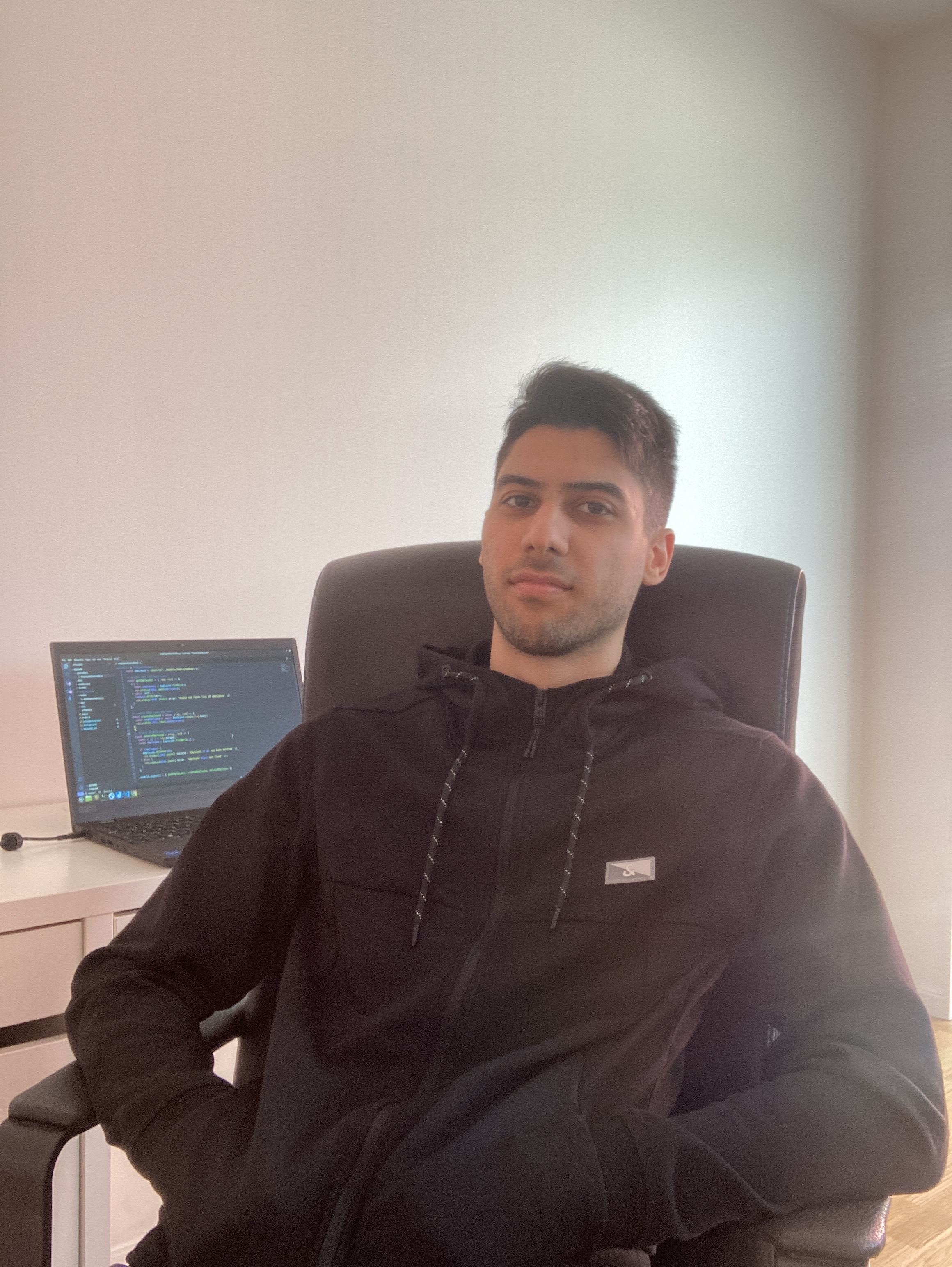 Fadi sitting at his desk